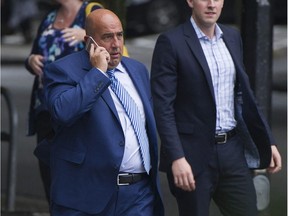 FILE PHOTO - Accused fraudster Mark Chandler (left) crosses the street on his way back to BC Supreme Court Friday, September 8, 2017 to attend his extradition hearing.