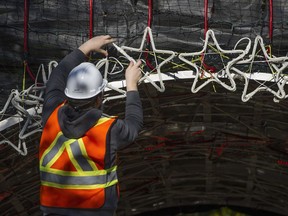 Volunteers erect the 20th Annual Lights of Hope display at St. Paul's hospital in Vancouver, BC Saturday, October 28, 2017. The annual Christmas-time event is a fundraiser for the St. Paul's hospital foundation. The lights will be officially illuminated November 16.