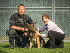 VPD officer Ray Wong, his dog Hunter and author Rachel Rose at VPD Kennels in Vancouver, B.C., October 4, 2017.