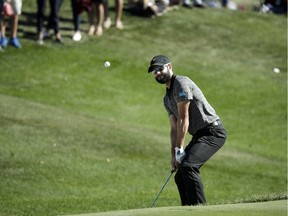 International Team member Adam Hadwin watches the flight of his ball on the third hole during the final round of the Presidents Cup golf tournament at Liberty National Golf Club in Jersey City, N.J., last Sunday.