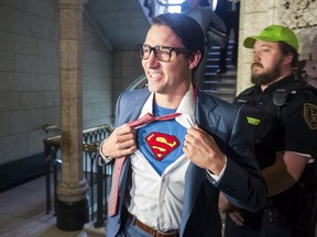 Prime Minister Justin Trudeau shows off his costume as Clark Kent, alter ego of comic book superhero Superman, as he walks through the House of Commons, in Ottawa on Tuesday, October 31, 2017. THE CANADIAN PRESS/Adrian Wyld ORG XMIT: AJW501
Adrian Wyld,