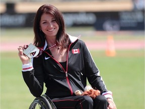 FILE PHOTO - Canada's Michelle Stilwell, holding a silver medal she won at the IPC Athletics World Championships in Lyon, France, in 2013. Stilwell, who is a B.C. MLA, has lost a similar gold medal while moving offices.