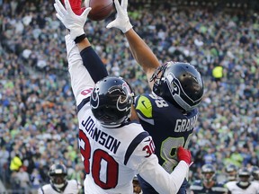 Houston Texans cornerback Kevin Johnson (30) breaks up a pass intended for Seattle Seahawks tight end Jimmy Graham, right, in the second half of an NFL football game, Sunday, Oct. 29, 2017, in Seattle. (AP Photo/Stephen Brashear)