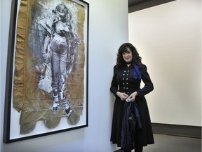 Artist Angela Grossman at the exhibition of her work at Vancouver's Winsor Gallery in April 2012. To the left is the work, The Future is Female.