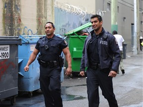 Const. Mike Bal, pictured in this 2012 file photo (right), has been named one of the world's top 40 under 40 law enforcement professionals. he is pictured here alongside Kal Dosanjh in Vancouver's Downtown Eastside while on patrol.