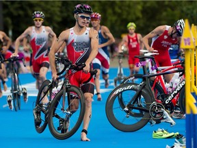 Canada's Brent McMahon runs from the transition zone as he races in the men's triathlon at Hyde Park during the Summer Olympics in London on Tuesday, August 7, 2012. Two Canadians return to the world Ironman championship seeking to crack Kona's code.