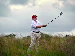 Trump playing a stroke as he officially opens his new multi-million pound Trump International Golf Links course in Aberdeenshire, Scotland
