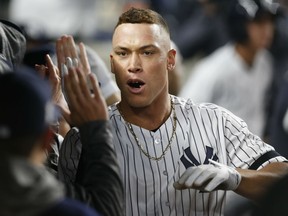 Aaron Judge celebrates in the dugout with his Yankees teammates after hitting a two-run home run during the fourth inning of the American League wild card game against the Minnesota Twins in New York on Tuesday night.