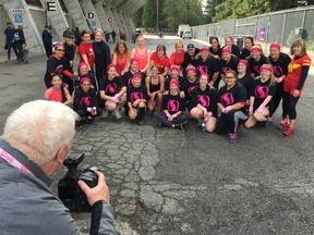 The fifth annual Woman2Warrior Vancouver Challenge's 10:45 a.m. wave has its pre-race photo taken on Saturday morning before tackling the 5K obstacle course in Burnaby Central Park. More than 225 women took part in the event.