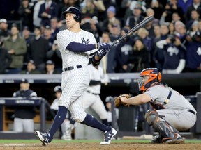 Aaron Judge of the New York Yankees follows through on a three-run homer in the fourth inning of Monday's Game 3 of the ALCS against the Houston Astros at Yankee Stadium. The Yankees won 8-1 to cut the series deficit to 2-1 with Game 4 today at Yankee Stadium.