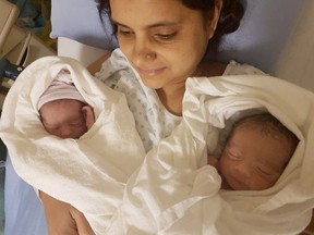Meena Devi holds her twin sons, born Monday at Victoria General Hospital. The twins father, Khushal Rana, died on Oct. 21, three days after he was hit by an SUV while walking along Gorge Road West.