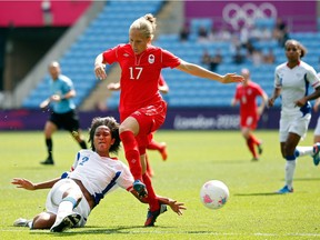 Brittany Timko Baxter (17) of Canada loses control of the ball against Wendie Renard of France during the women's bronze-medal game at the 2012 Olympics at City of Coventry Stadium on Aug. 9 in England.