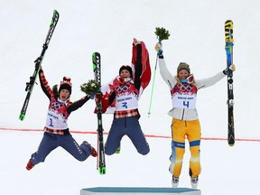 Marielle Thompson (C) of Canada celebrates winning the gold medal with silver medallist Kelsey Serwa (L) of Canada and bronze medallist Anna Holmlund of Sweden during the flower ceremony in the Freestyle Skiing Womens' Ski Cross Final on day 14 of the 2014 Winter Olympics at Rosa Khutor Extreme Park on February 21, 2014 in Sochi, Russia