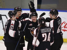 Ty Ronning (centre) of the Vancouver Giants celebrates his goal against the Edmonton Oil Kings with teammates Tyler Benson #17, Brad Morrison #10, Milos Roman #40 and Matt Barberis #24 during the first period of their WHL game at the Langley Events Centre on November 12, 2017 in Langley.