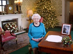 Queen Elizabeth II sits at a desk in the Regency Room after recording her Christmas Day broadcast to the Commonwealth at Buckingham Palace on December 24, 2016 in London, England.