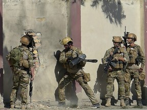 Afghan security personnel take position after gunmen disguised as policemen stormed a television station in Kabul on November 7, 2017.