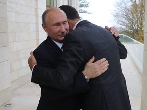 Russia President Vladimir Putin (left) embraces his Syrian counterpart Bashar al-Assad during a meeting in Sochi, Russia, on Nov. 20, 2017.