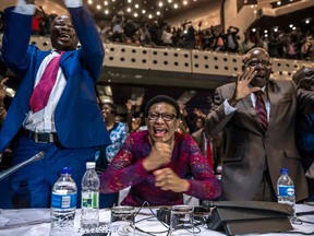 Zimbabwe's members of parliament celebrate after Mugabe's resignation on November 21, 2017 in Harare.