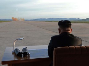 This undated picture released from North Korea's official Korean Central News Agency (KCNA) on September 16, 2017 shows North Korean leader Kim Jong-Un inspecting a launching drill of the medium-and-long range strategic ballistic rocket Hwasong-12 at an undisclosed location.