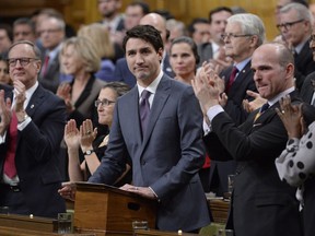 Prime Minister Justin Trudeau receives applause while he makes a formal apology to individuals harmed by federal legislation, policies, and practices that led to the oppression of and discrimination against LGBTQ2 people in Canada, in the House of Commons in Ottawa, Tuesday, Nov.28, 2017. THE CANADIAN PRESS/Adrian Wyld
