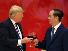 President Donald Trump, left and Vietnamese President Tran Dai Quang attend a State Dinner at the International Convention Center, Saturday, Nov. 11, 2017, in Hanoi, Vietnam. President Trump says the United States will no longer join large trade agreements, but instead will pursue one-on-one deals with nations that pledge allegiance to fair and reciprocal trade. Trump pulled the U.S. out of the 12-nation Trans-Pacific Partnership trade agreement. He says sweeping trade agreements "tie our hands, surrender our sovereignty and make meaningful enforcement practically impossible." (AP Photo/Andrew Harnik)