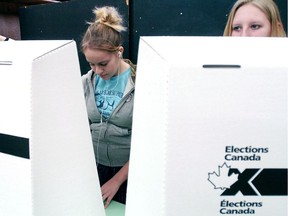 FILE PHOTO -  Grade 10 students (from left) Robert Sage, Caitlin Thornton and Cassie Daniels vote at a voting booth as they participate in Student Vote Canada at Crestwood Secondary School in Peterborough, Ont. on Thursday, Jan. 19, 2006.