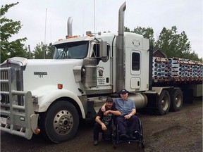 Robert Price, left, and his father Dougie Price pose in front of Robert's truck in Tabusintac, N.B. in this undated handout photo. A British Columbia man is facing several charges including kidnapping and use of a firearm after a semi-tractor trailer and its driver were allegedly commandeered by an armed assailant earlier this week.