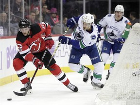 Stefan Noesen of the New Jersey Devils is pursued by Vancouver Canucks' defenceman Michael Del Zotto during Friday's NHL game in Newark, N.J. The Canucks were unable to catch the Devils.
