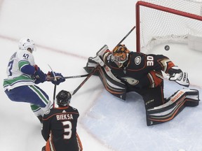 Vancouver Canucks left wing Sven Baertschi, left, scores past Anaheim Ducks goalie Ryan Miller, right, as Kevin Bieksa watches during the first period of an NHL hockey game in Anaheim, Calif., Thursday, Nov. 9, 2017. (AP Photo/Chris Carlson) ORG XMIT: ANA106 Chris Carlson, AP