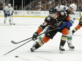 Logan Shaw is chased by Sam Gagner in the second period of Anaheim's 4-1 win over Vancouver Thursday night in California.