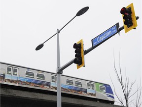 A train moves along the Canada Line at No. 3 Road and Capstan Way in Richmond.