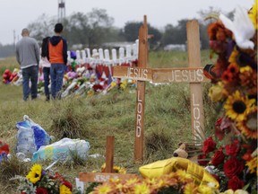 Mourners visit a makeshift memorial for the victims of the shooting at Sutherland Springs Baptist Church, Sunday, Nov. 12, 2017, in Sutherland Springs, Texas. A man opened fire inside the church in the small South Texas community a week ago, killing more than two dozen. (AP Photo/Eric Gay) ORG XMIT: TXEG105
Eric Gay, AP