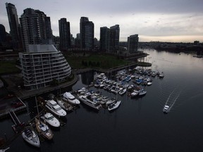 A water taxi passes by a marina and downtown condos while traveling on False Creek in Vancouver, B.C., on Wednesday, February 11, 2015. From the slow-paced, tree-lined streets of downtown Charlottetown, to the modern, western architecture of metro Vancouver, Canada's urban waterfronts are a beacon for condo developers, tourists and everyone in between.