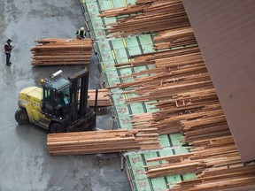 Workers sort and move lumber at the Delta Cedar Sawmill in Delta, B.C., on Friday January 6, 2017. Canada is turning to NAFTA in its bid to stop U.S. duties on Canadian softwood lumber.THE CANADIAN PRESS/Darryl Dyck