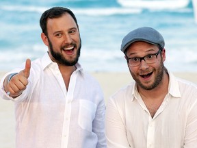 FILE - This April 21, 2013 file photo shows Evan Goldberg, left, and Seth Rogen, posing on a beach as they promote their film "This is The End", in Cancun, Mexico.