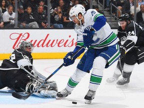 Jonathan Quick makes the save against Brandon Sutter .