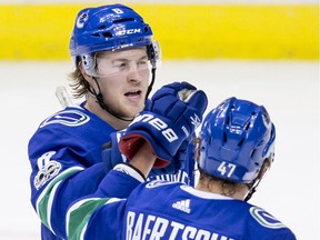 Vancouver Canucks Brock Boeser (top) and Sven Baertschi celebrate Boeser's second of what would be three goals on the night against the Pittsburgh Penguins during the second period of their NHL game at Vancouver’s Rogers Arena on Nov. 4, 2017. The Canucks won 4-2.