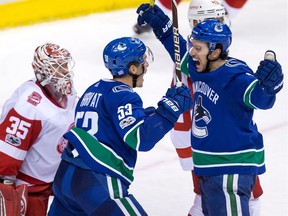 Michael Del Zotto, right, celebrates his tying goal in the third period with Bo Horvat. It was his first as a Canuck.