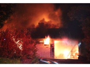 Firefighters battle a large house fire in Surrey early Friday morning. All six members of the same family escaped unharmed.