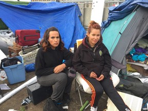 Eagle McGilvery, 20, left, and her sister, Cherise O., 21, live at the tent city off Powell Street in East Vancouver because they don't have homes. They said police and firefighters on Nov. 7 removed all of the camp's propane heaters and stoves due to fire hazards.