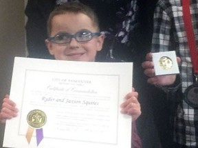 Ryder Squires with the commendation he and brother Jaxson received from the city of Vancouver for putting the needs of others above their own.