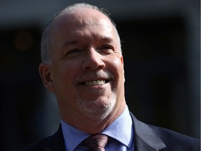 Premier John Horgan speaks to media from the Rose Garden at Legislature in Victoria, B.C., on Wednesday, October 4, 2017