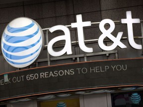 The AT&T corporate logo is positioned above one of its retail stores in New York in October 2016. AT&T is trying to buy out Time Warner in a US $85-billion deal.