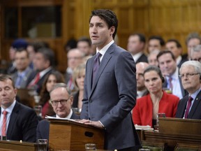 Prime Minister Justin Trudeau makes a formal apology to individuals harmed by federal legislation, policies, and practices that led to the oppression of and discrimination against LGBTQ2 people in Canada, in the House of Commons in Ottawa, Tuesday, Nov.28, 2017.