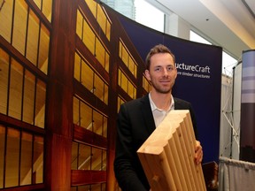 Lucas Epp, engineering and 3D manager at StructureCraft Builders Inc., displays a sample of the dowel-laminated timber products that the company has begun manufacturing at its new, state-of-the-art facility in Abbotsford.