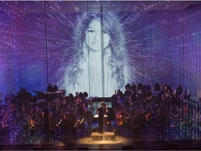 The National Arts Centre Orchestra's multimedia presentation of My Name is Amanda Todd, seen here on stage behing a scrim curtain, is part of Life Reflected, the opening event for World New Music Days 2017.