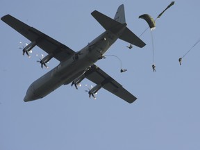 Army paratroopers from 3rd Battalion, Princess Patricia's Canadian Light Infantry (3PPCLI) based in Edmonton, jump from a CC-130J Hercules aircraft during an airborne insertion into the Oleszno training area of Poland as part of NATO reassurance exercises on July 11, 2014.