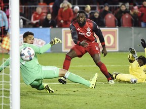 Toronto FC forward Jozy Altidore (17) scores on Columbus Crew goalkeeper Zack Steffen (23) as Crew defender Lalas Abubakar (17) looks on during second half MLS eastern conference final playoff soccer action in Toronto on Wednesday, November 29, 2017. THE CANADIAN PRESS/Nathan Denette