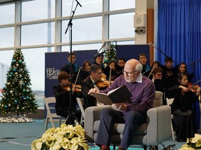 WestJet surprised guests travelling from Vancouver to Calgary with a special performance at YVR with the Vancouver Metropolitan Orchestra, Wings Vocal Collective and a reading of "The Night Before Christmas" with Canadian icon Peter Mansbridge.  [PNG Merlin Archive]
Handout/WestJet, PNG