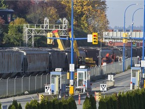 Cranes mark the spot where a train derailed along a rail line inside the secured area of the Port of Vancouver, Wednesday, November 1, 2017.